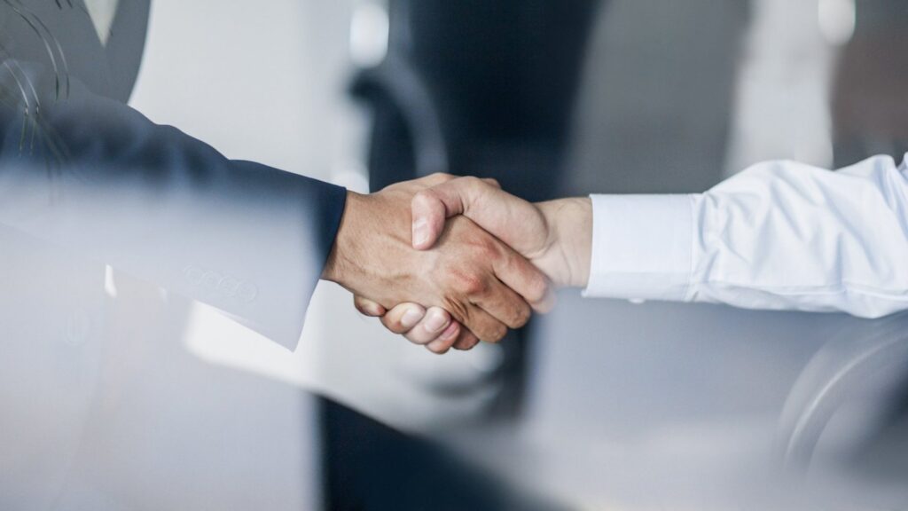 Image of handshake to demonstrate how custom video conferencing builds relationships