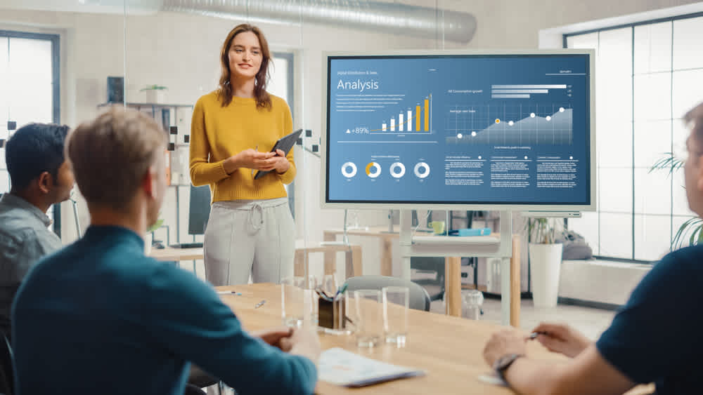 Photo of women presenting in boardroom to show how to deliver a business pitch.