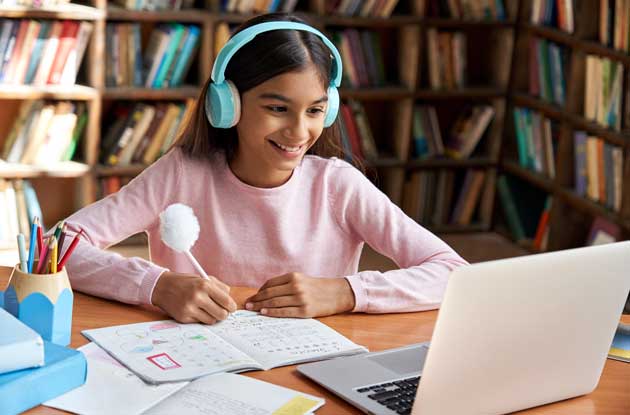 Young girl learning through online tutoring though custom video conferencing
