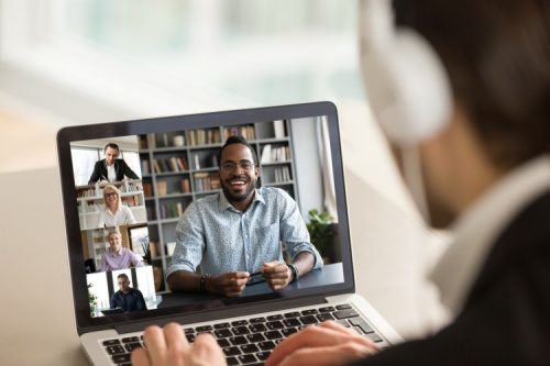 Photo of man video conferencing showing screen for virtual meetings