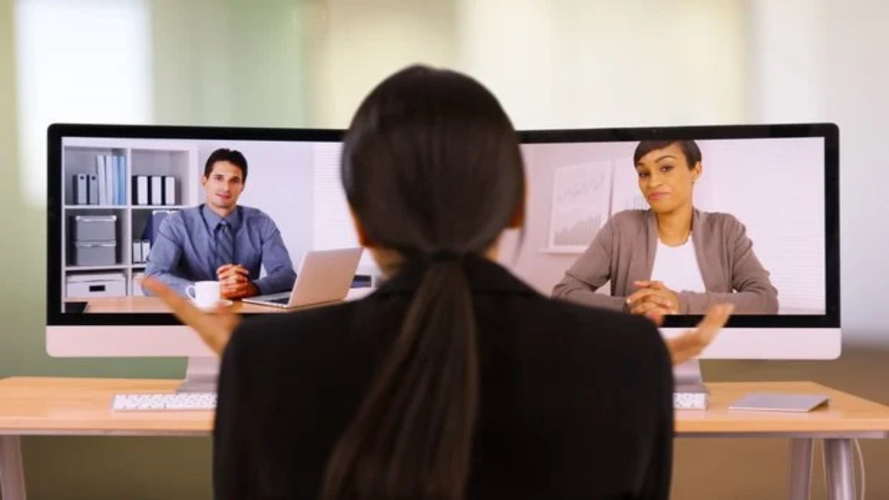 Woman and lawyer in front of two desktops for ProVideoMeeting